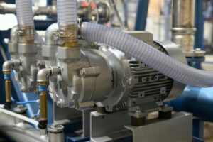Two vacuum pumps installed on a shop floor.